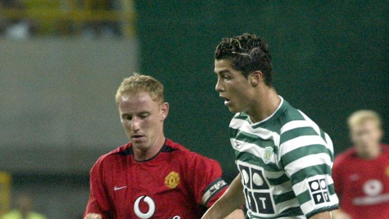Sporting's player Cristiano Ronaldo (R) figths for the ball with  unidentified Manchester United player during a friendly match at the inauguration of a new Sporting Stadium