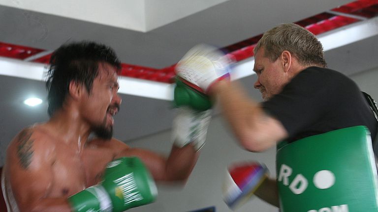Philippine boxing hero Manny Pacquiao (L) trains with his coach Freddie Roach at a gym in General Santos City, on the southern island of Mindanao on October 24, 2013 ahead of his upcoming bout with US boxer Brandon Rios in Macau on November 24. Pacquiao says he is furiously training like a 20-year-old to break a losing streak and re-establish his reputation as one of the world's best fighters.   