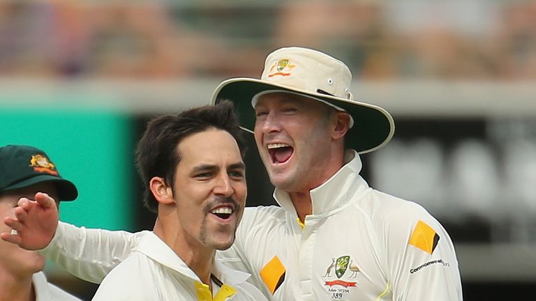 Mitchell Johnson of Australia celebrates with Michael Clarke after dismissing Joe Root of England during day two of the First Ashes Test match between Australia and England at The Gabba on November 22, 2013 in Brisbane, Australia