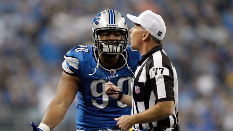 Defensive end Ndamukong Suh of the Detroit Lions argues with referee Terry McAulay after Suh is ejected from the game for unsportsmanlike conduct against the Green Bay Packers during the Thanksgiving Day 2011