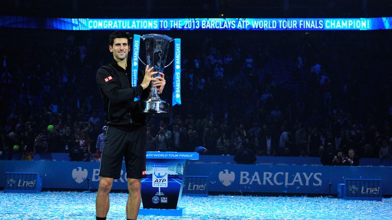 Serbia's Novak Djokovic poses with the Brad Drewett Trophy after beating Spain's Rafael Nadal in the singles final on the eighth day of the ATP World Tour Finals tennis tournament in London on November 11, 2013. Djokovic won 6-3, 6-4