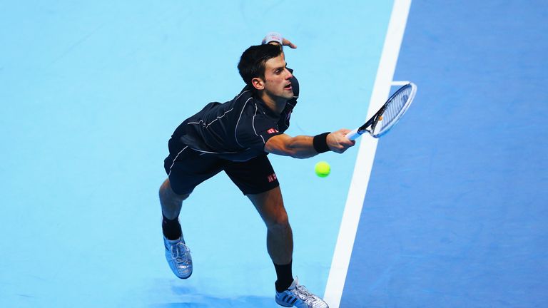 Novak Djokovic of Serbia hits a forehand in his men's singles semi-final match against Stanislas Wawrinka of Switzerland at the ATP World Tour Finals