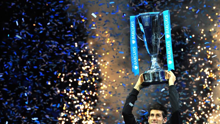 Serbia's Novak Djokovic poses with the Brad Drewett Trophy after beating Spain's Rafael Nadal in the singles final on the eighth day of the ATP World Tour Finals tennis tournament in London on November 11, 2013. Djokovic won 6-3, 6-4