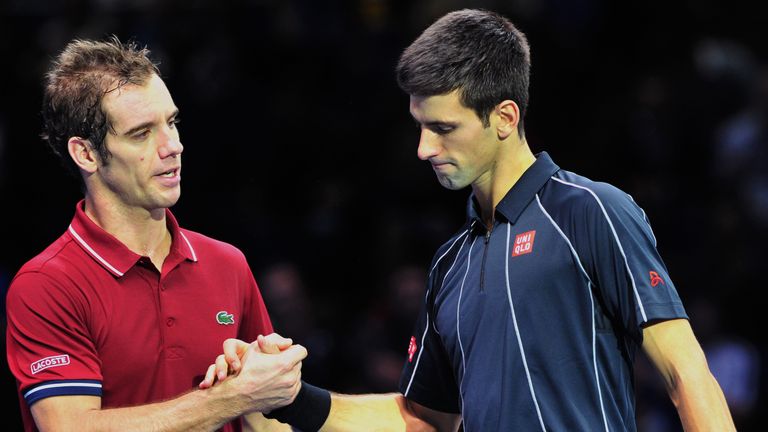 Novak Djokovic shakes hands with Richard Gasquet after winning their group B singles match in the round robin stage on the sixth day of the ATP World Tour Finals