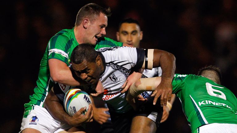 Petero Civoniceva of Fiji is tackled by Ireland's Ben Currie (L) and James Mendeika during the Rugby League World Cup Group A match between Fiji and Ireland at Spotland Stadium