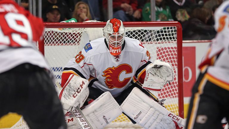 Reto Berra #29 of the Calgary Flames follows the action in his NHL debut against the Chicago Blackhawks at the United Center on November 3, 2013 in Chicago, Illinois. The Flames defeated the Blackhawks 3-2 in overtime.  
