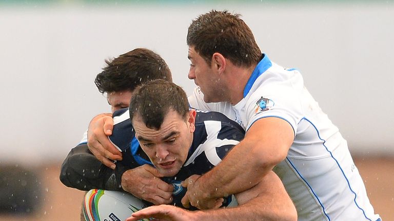 Kane Linnett of Scotland  powers through the Italy defence during the Rugby League World Cup Group C match between Scotland and Italy at Derwent Park on November 3, 2013 in Workington, England.