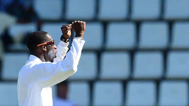 West Indies bowler Shane Shillingford (C) celebrates after taking the wicket of Australian batsman Ricky Ponting during the first day of the third test match between the West Indies and Australia in Roseau, Dominica, April 23, 2012. Australia is leading the the three-test series 1-0.  