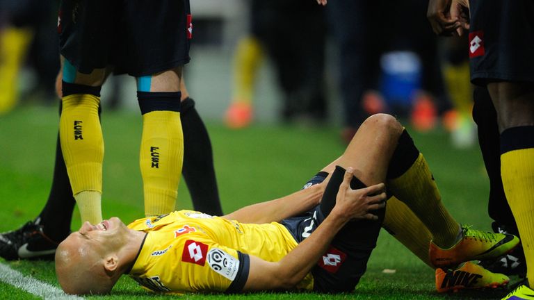 Sochaux's French midfielder Thomas Guerbert holds his right leg after being injured during the French L1 football match Sochaux (FCSM) against Saint Etienne (ASSE) on November 2, 2013, at the Auguste Bonal Stadium in Montbeliard, eastern France