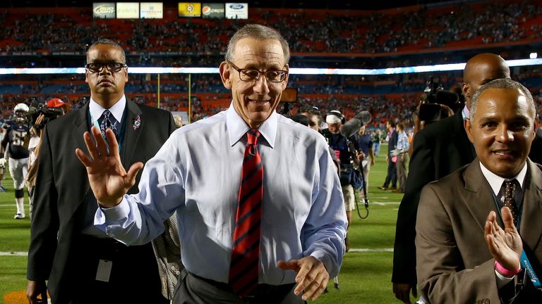 Miami Dolphins owner Stephen Ross celebrates as he walks off the field after his team defeated the San Diego Chargers