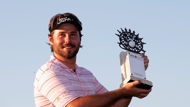 Victor Dubuisson of France poses with the trophy after winning the Turkish Airlines Open