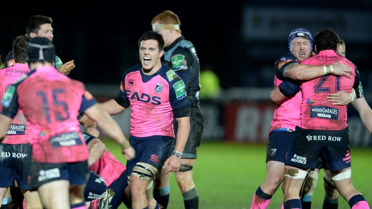The Cardiff Blues players celebrate after the final whistle
