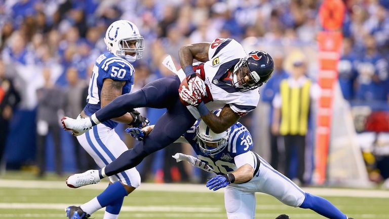 Andre Johnson #80 Houston Texans is tackled by LaRon Landry #30 of the Indianapolis Colts
