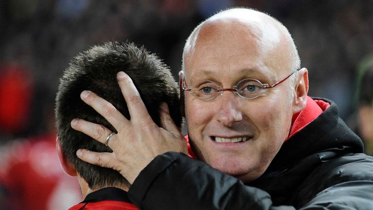 Toulon's coach Bernard Laporte embraces a player after winning the French Top 14 semifinal rugby union match Toulon vs Toulouse on May 24, 2013