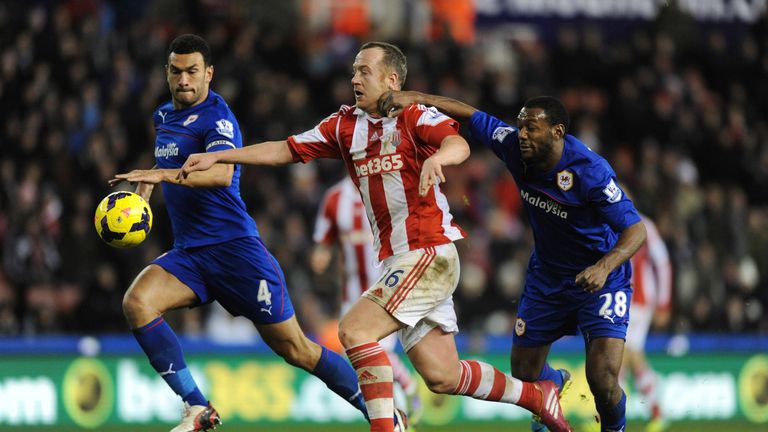 Charlie Adam of Stoke City is pulled back by Kevin Theophile-Catherine of Cardiff City during the Barclays Premier League