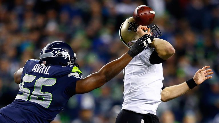Defensive end Cliff Avril of the Seattle Seahawks knocks the ball from quarterback Drew Brees of the New Orleans Saints 