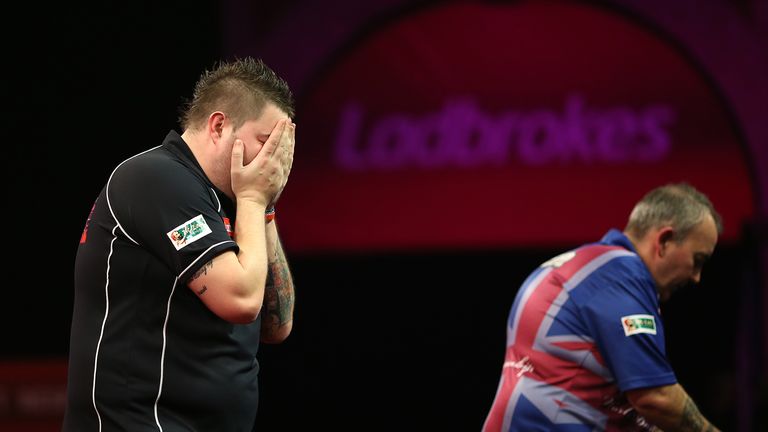 Michael Smith celebrates after winning his second round match against Phil Taylor during the PDC World Darts Championship at Alexandra Palace