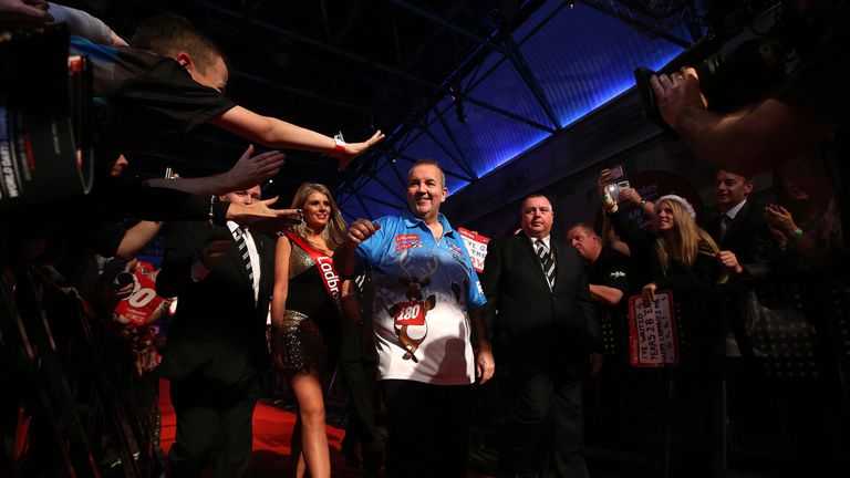 Phil Taylor walks towards the oche at Alexandra Palace before first-round win over Rob Szabo at PDC World Championship. Dec 13 2013.