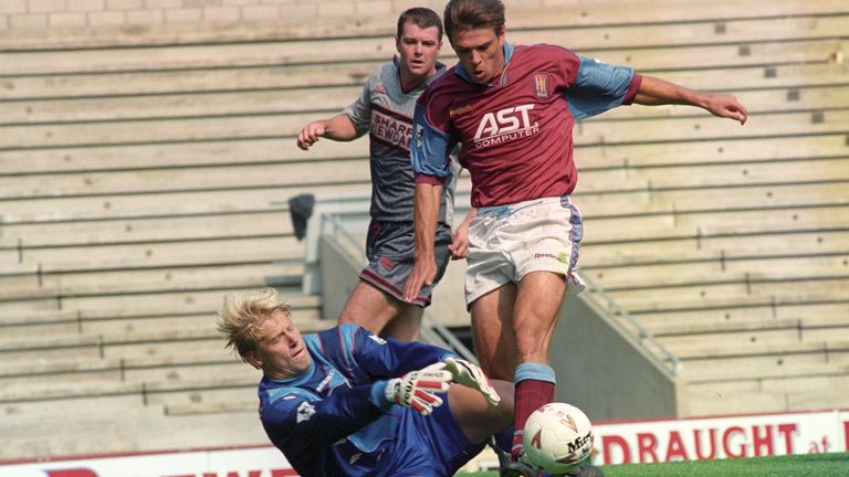 MANCHESTER UNITED'S PETER SCHMEICHELnBRINGS DOWN ASTON VILLA'S SAVOnMILOSEVIC TO GIVE AWAY A PENALTY ANDnVILLA'S THIRD GOAL OF THE FIRST HALF ATnVILLA 