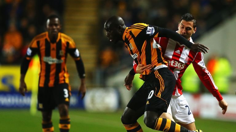 Yannick Sagbo (left) of Hull City holds off the challenge of Geoff Cameron of Stoke City (right) at the KC Stadium