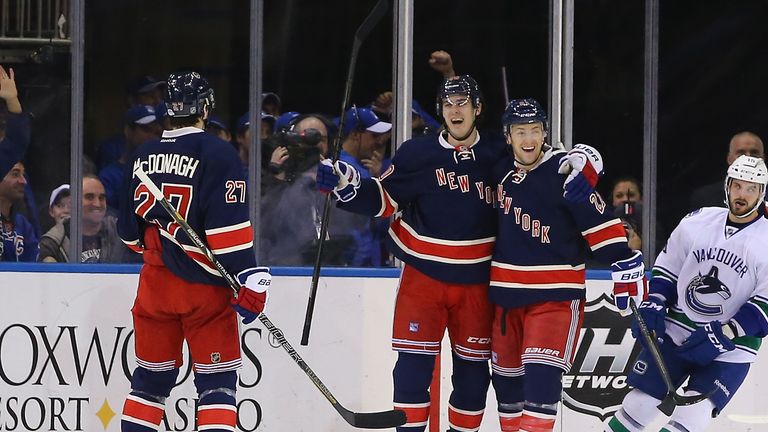 Chris Kreider #20 celebrates scoring a goal in the first period with Ryan McDonagh #27, and Derek Stepan #21 of the New York Rangers against the Vancouver Canucks