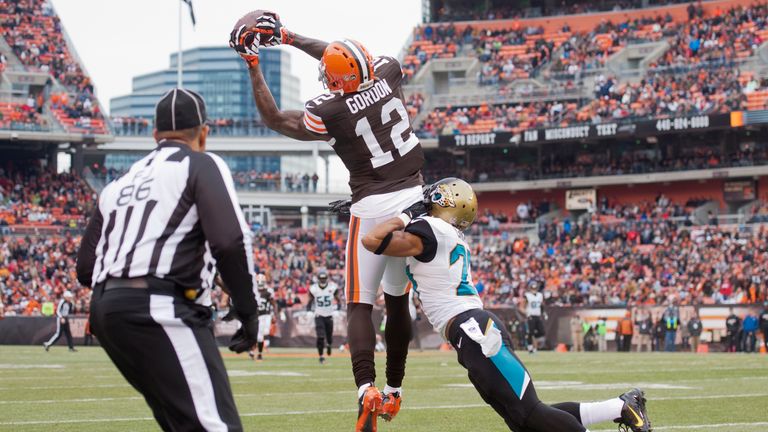 Wide receiver Josh Gordon #12 of the Cleveland Browns catches a pass under pressure from cornerback Dwayne Gratz #27 of the Jacksonville Jaguars during the first half at FirstEnergy Stadium on December 1, 2013 in Cleveland, Ohio