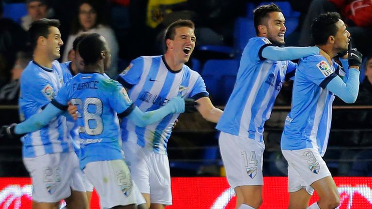 Malaga's Brazilian defender Weligton (R) celebrates with his teammates after scoring during the Spanish league match Villareal vs Malaga at El Madrigal.