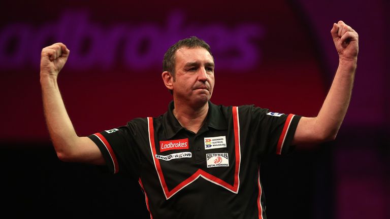 Richie Burnett celebrates winning a leg during his second round match against Andy Hamilton at the PDC World Darts Championship