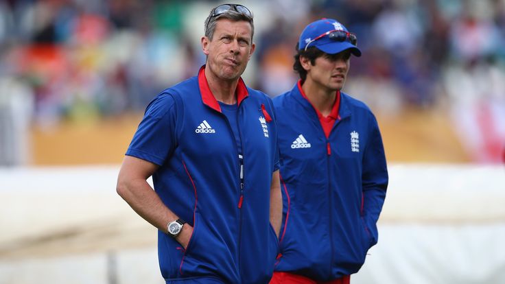 Ashley Giles, oach of England and captain Alastair Cook (R) walk back to the pavillion after inspecting the pitch 