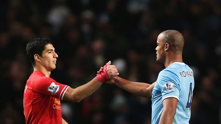  Luis Suarez of Liverpool shakes hands with Vincent Kompany of Manchester City.