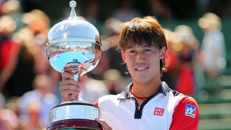 - Nishikori of Japan poses with the Kooyong Classic trophy after winning his match against Tomas Berdych of the Czech Republic