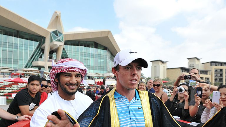 Rory McIlroy is presented with a traditional Emirati Bisht