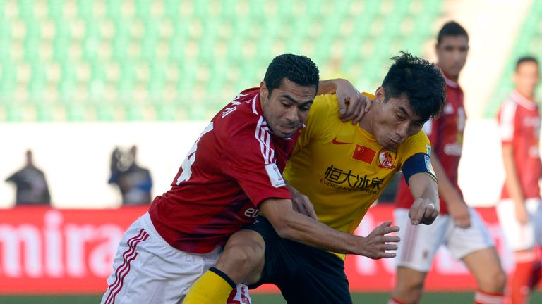 Guangzhou's Chinese midfielder Zheng Zhi (R) defends against Al Ahly's Egyptian mildfielder Ahmed Fathy (L) during their FIFA Club World Cup quarter final 