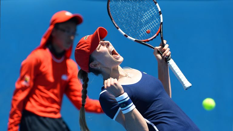 Alize Cornet of France reacts as she beats Camila Giorgi of Italy in their women's singles second round match on day four of the 2014 Australian Open