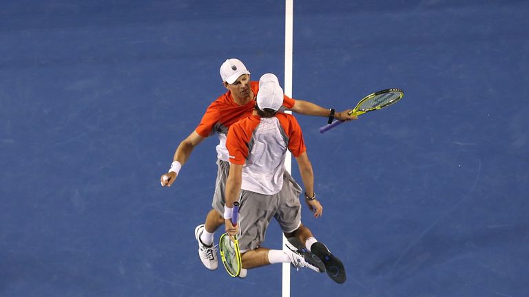Bob and Mike Bryan celebrate winning a match at the 2013 Australian Open