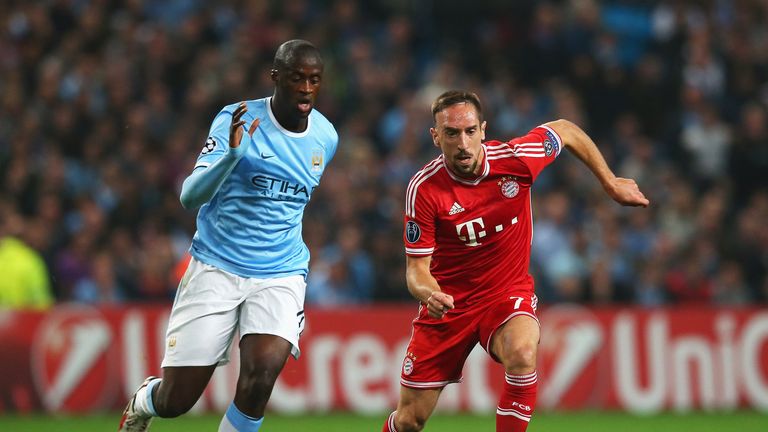 MANCHESTER, ENGLAND - OCTOBER 02:  Franck Ribery of Muenchen takes on Yaya Toure of Manchester City during the UEFA Champions League Group D match between 