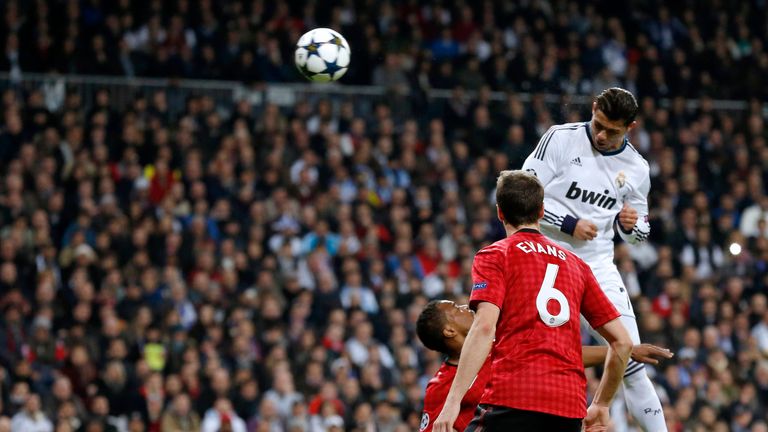 Real Madrid's Portuguese forward Cristiano Ronaldo (top) heads the ball to score during the UEFA Champions League match against Manchester United