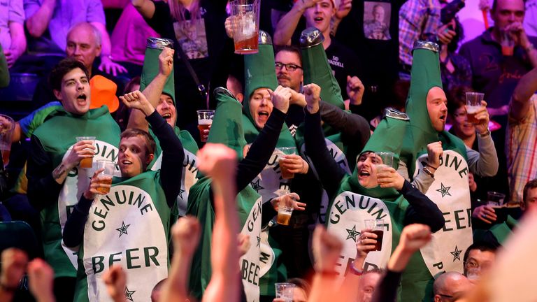 Darts fans dressed up in beer bottle costumes at World Darts Championship on Day Two at Alexandra palace