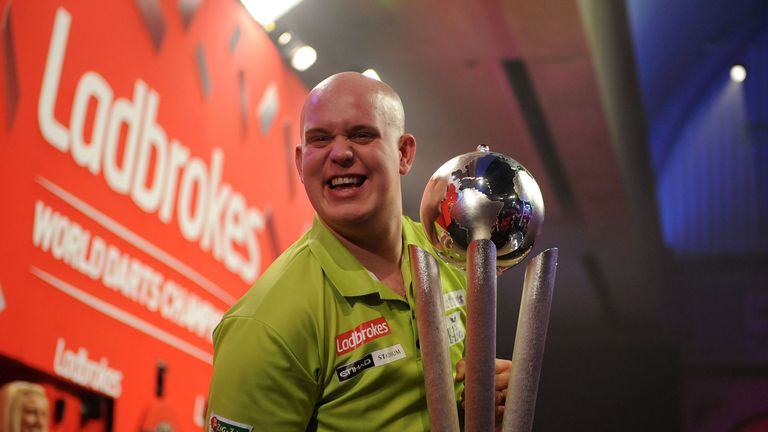 Michael Van Gerwen smiles as he holds the Sid Waddell trophy after winning the final of The Ladbrokes World Darts Championship at Alexandra Palace