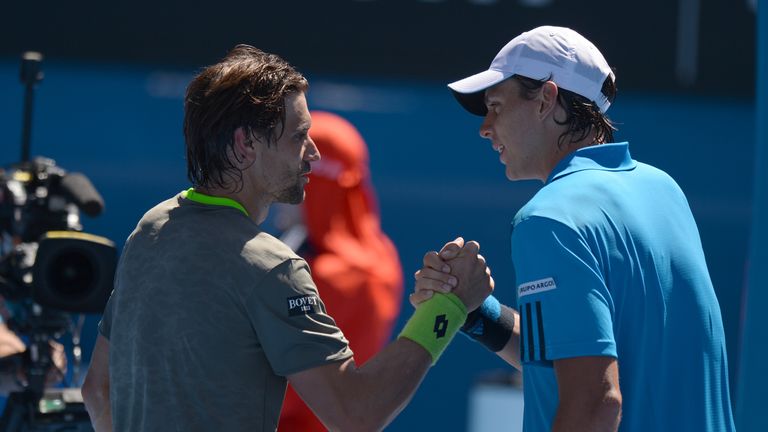 Spain's David Ferrer (L) shakes hands after victory in his men's singles match against Colombia's Alejandro Gonzalez (R) at the Australian Open