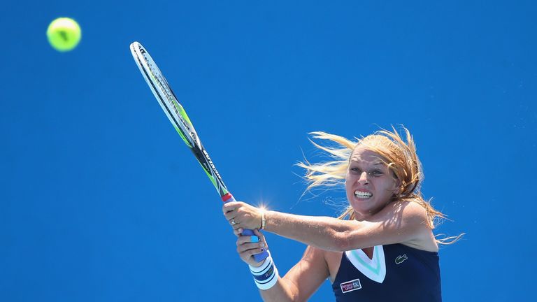 Dominika Cibulkova of Slovakia plays a backhand in her second round match against Stefanie Voegele of Switzerland at the Australian Open
