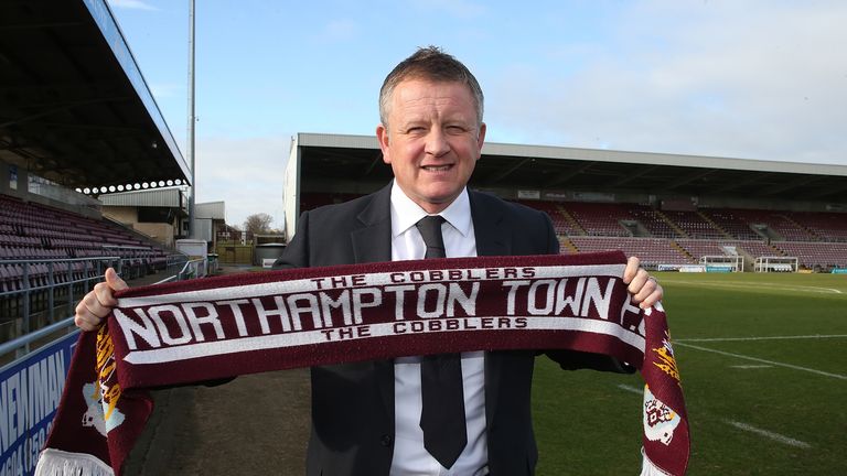 NORTHAMPTON, ENGLAND - JANUARY 27:  New Northampton Town manager Chris Wilder poses with a scarf during a press conference at Sixfields on January 27, 2014