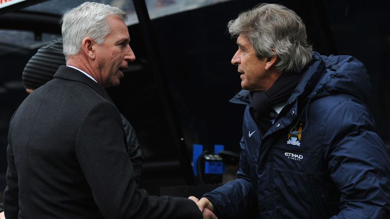 NEWCASTLE UPON TYNE, ENGLAND - JANUARY 12:  Manchester City manager Manuel Pellegrini (r) greets Alan Pardew before the Barclays Premier League