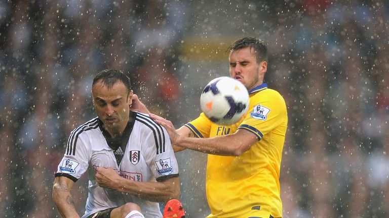 Dimitar Berbatov of Fulham and Carl Jenkinson of Arsenal tussle for the ball during at Craven Cottage.