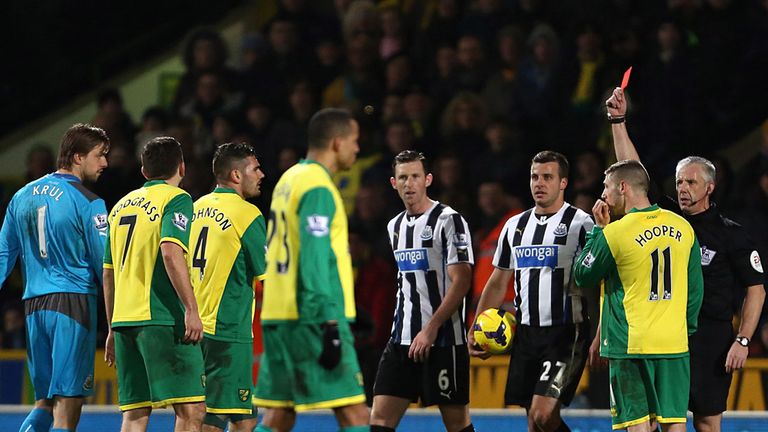 Norwich City's Bradley Johnson (third from left) is shown a red card by referee Chris Foy