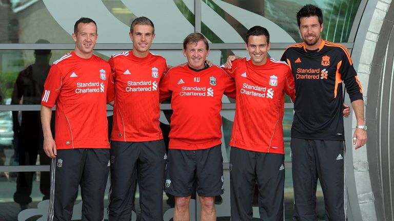 Liverpool's new summer signings Charlie Adam (L), Jordan Henderson (2nd L),Stewart Downing (2nd R) and Alexander Doni (R) pose for pictures with manager Ke
