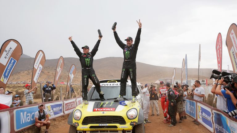 Nani Roma (R) and Michel Perin celebrate victory in the Dakar Rally