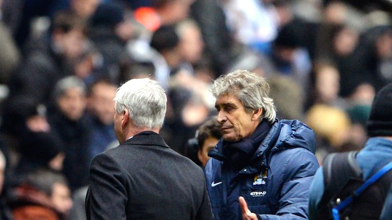 NEWCASTLE UPON TYNE, ENGLAND - JANUARY 12:  (L-R) Alan Pardew the Newcastle manager shakes hands with Manuel Pellegrini the Manchester City manager