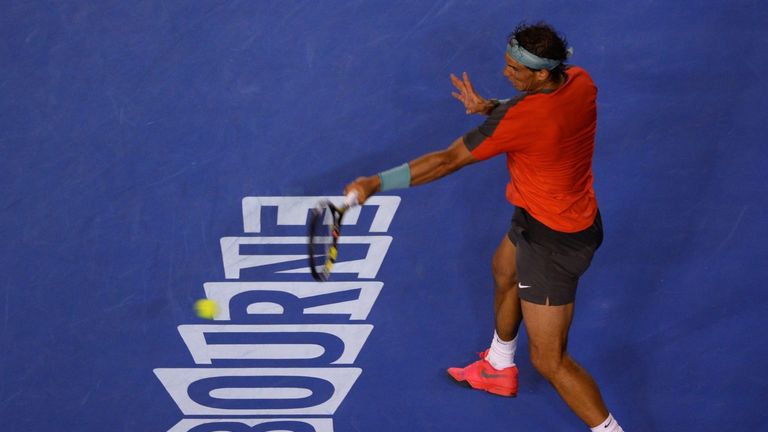Rafael Nadal of Spain hits a return against Roger Federer of Switzerland during their men's singles semi-final match on day 12 of the 2014 Australian Open 