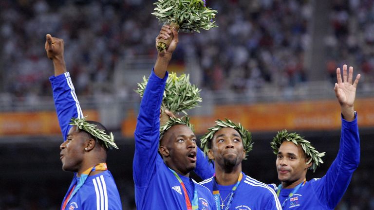 The British relay team celebrate with their gold medal on the podium of the men's 4x100m relay final at the Olympic Stadiumin 2004
